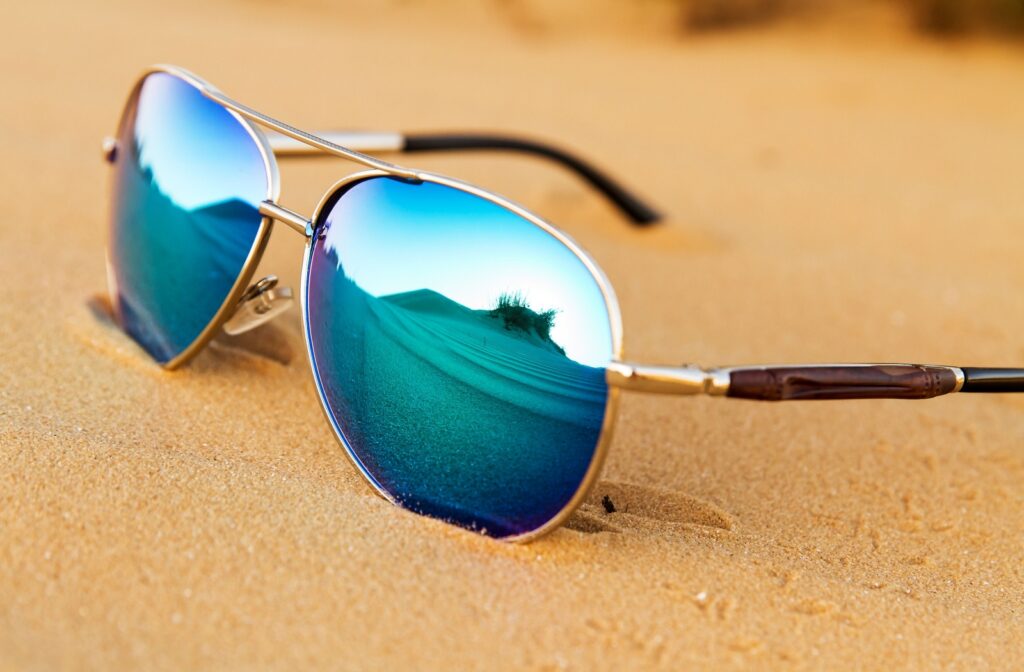 Pair of sunglasses in the sand.